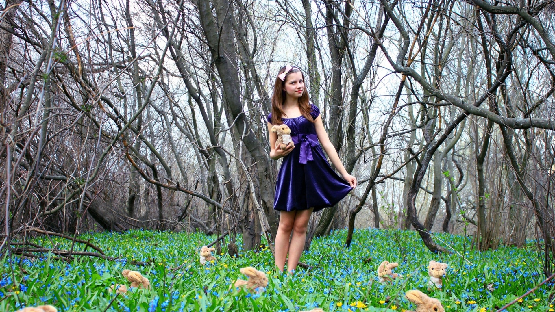 Girl in forest with stuffed animals