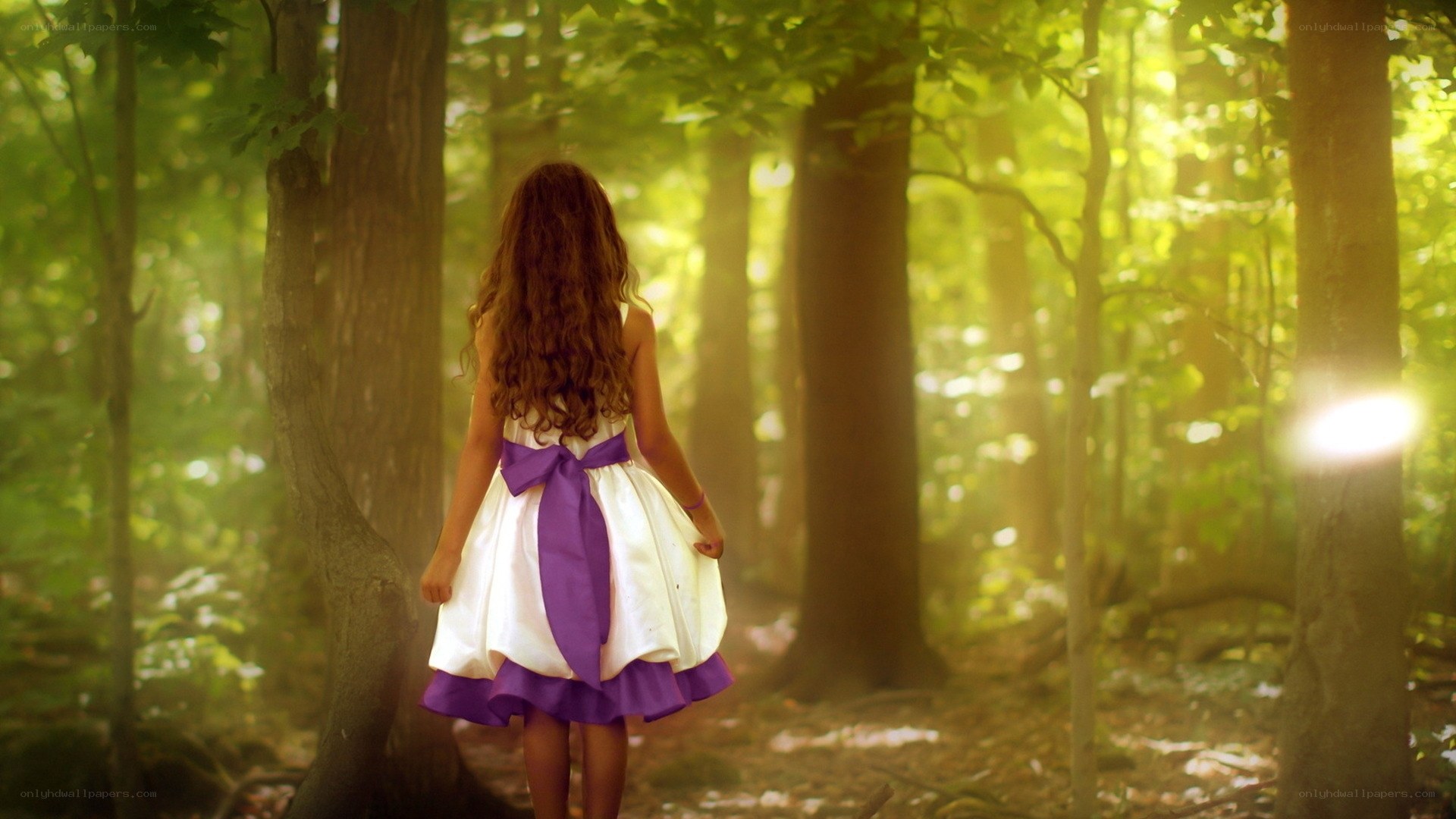 Girl in forest with sunlight
