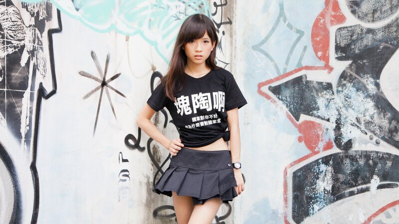 Girl in front of graffiti wall