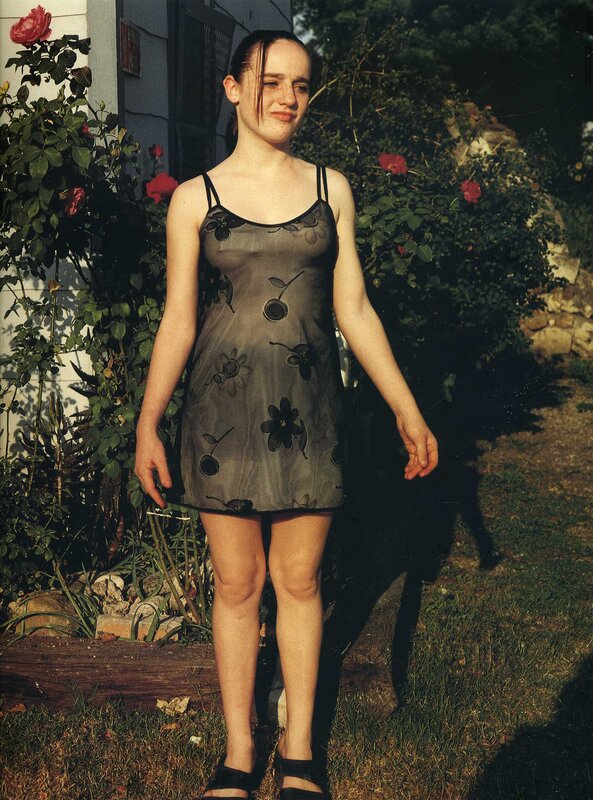 Girl in garden with roses
