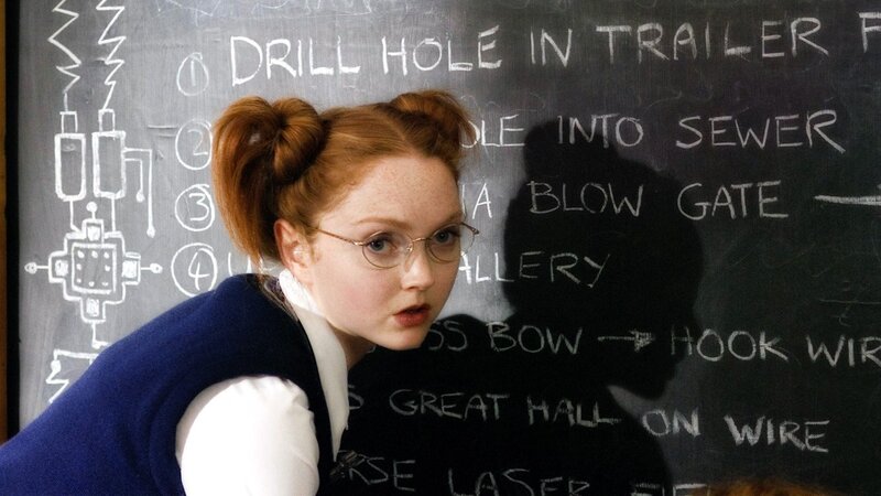 Girl in glasses by chalkboard