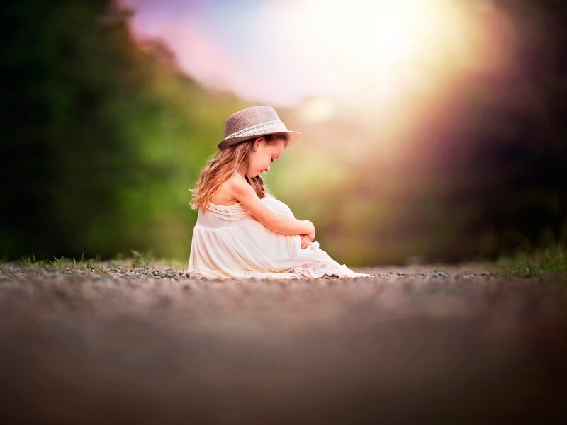 Girl in Hat Sitting