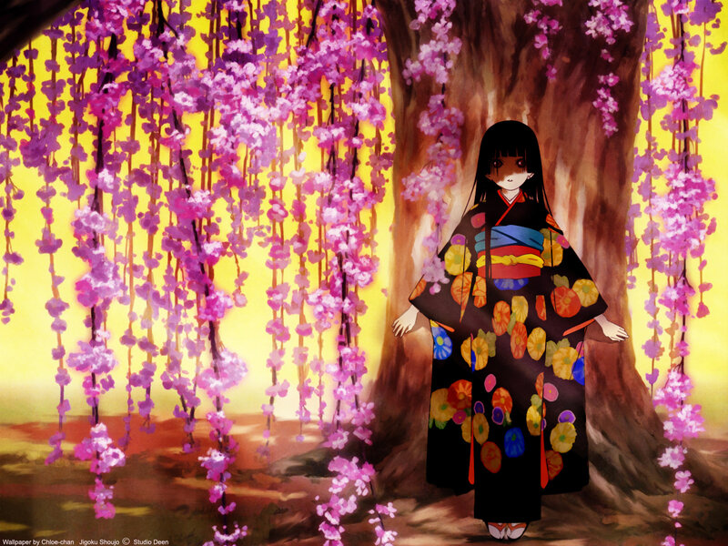 Girl in kimono under cherry blossoms