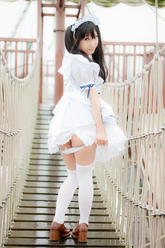 girl in maid costume on bridge