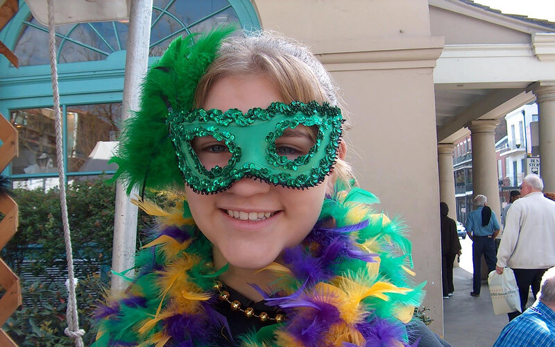 girl in mardi gras mask