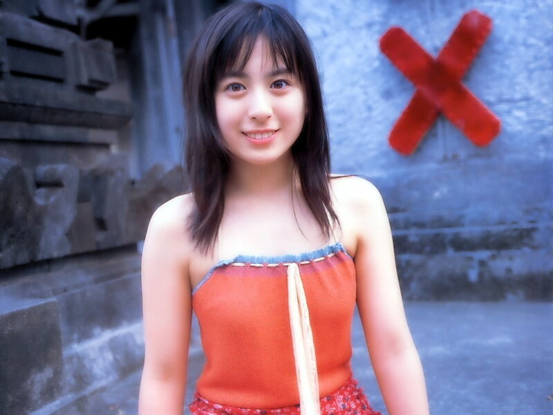 girl in orange top smiling