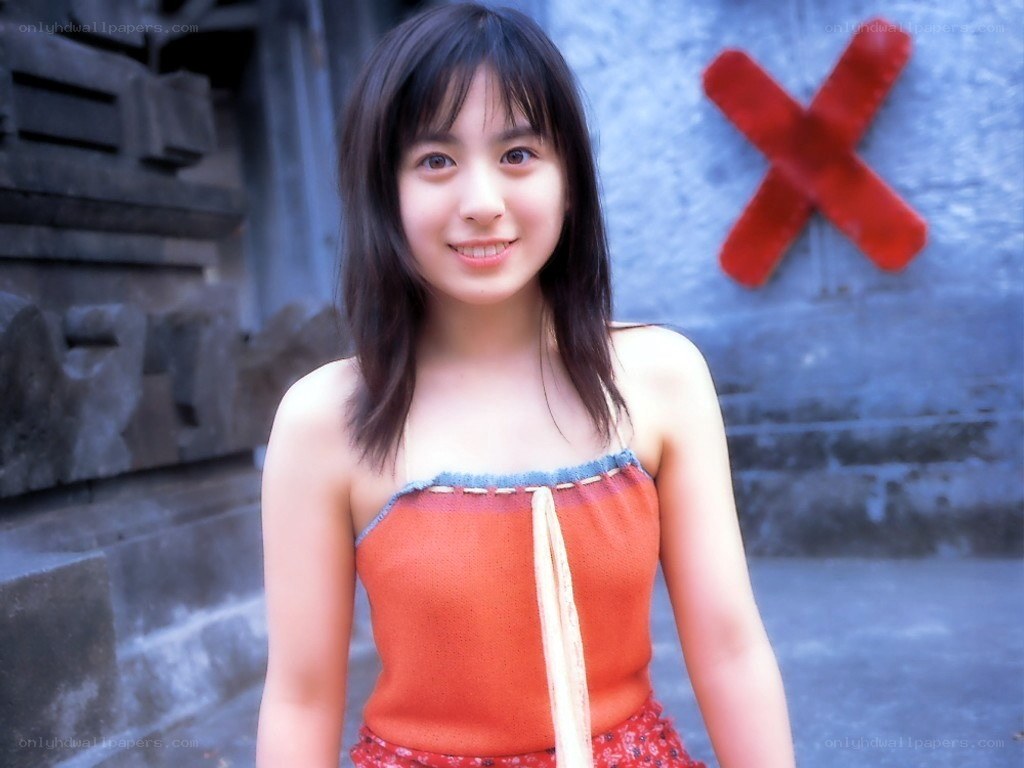girl in orange top smiling