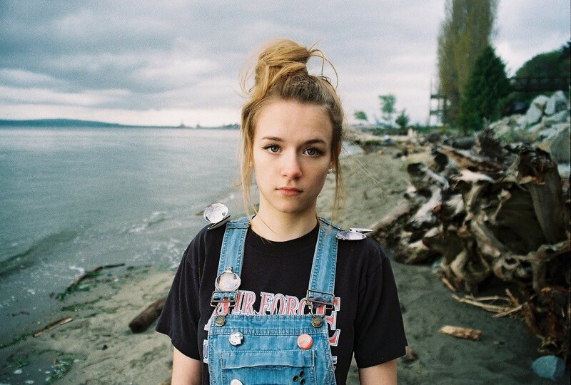 Girl in overalls on a beach