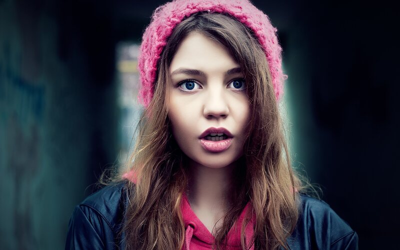 girl in pink hat looking surprised