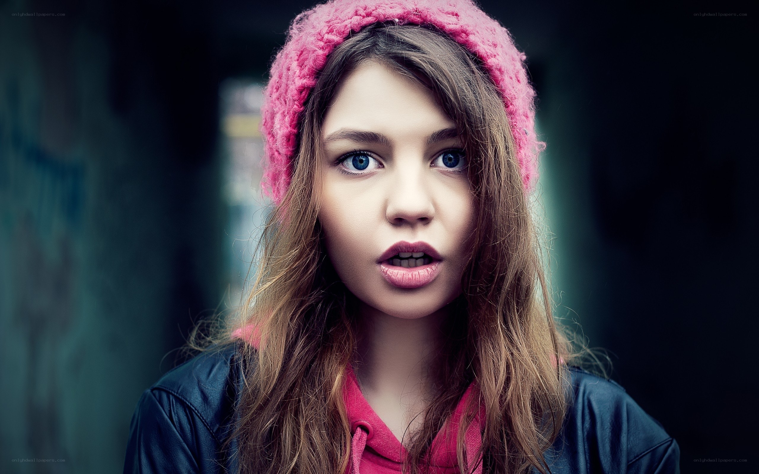 girl in pink hat looking surprised