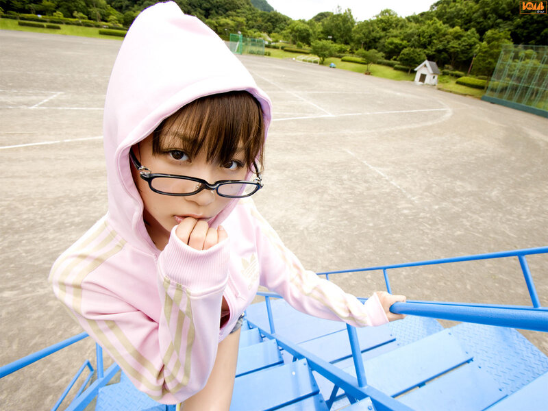 girl in pink hoodie on bleachers