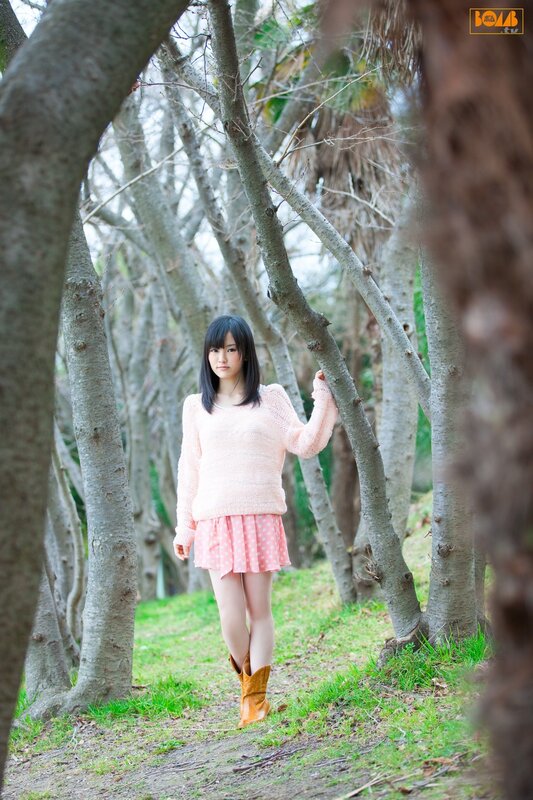 Girl in pink sweater forest