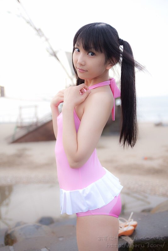 Girl in pink swimsuit at beach