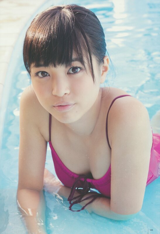 girl in pink swimsuit at pool