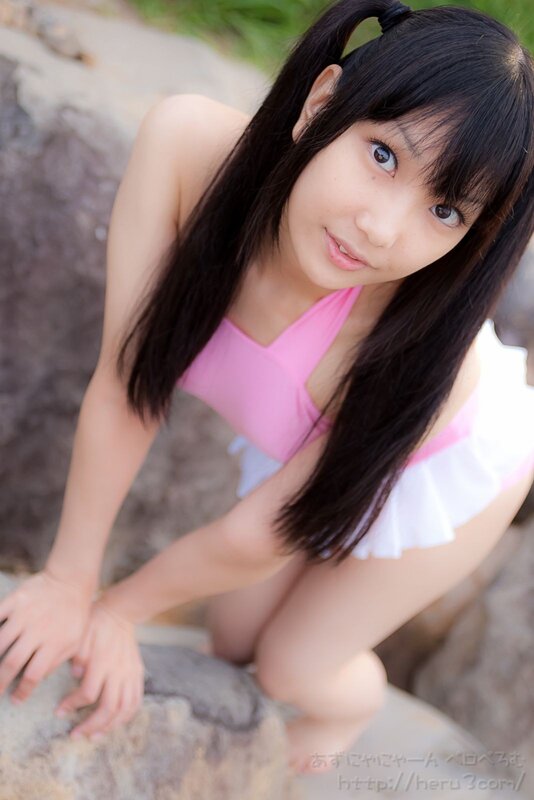 girl in pink swimsuit on rocks