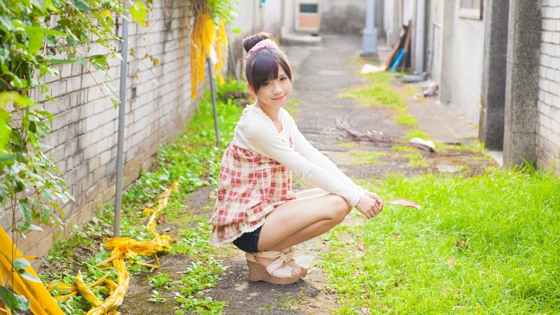 Girl in plaid dress crouching