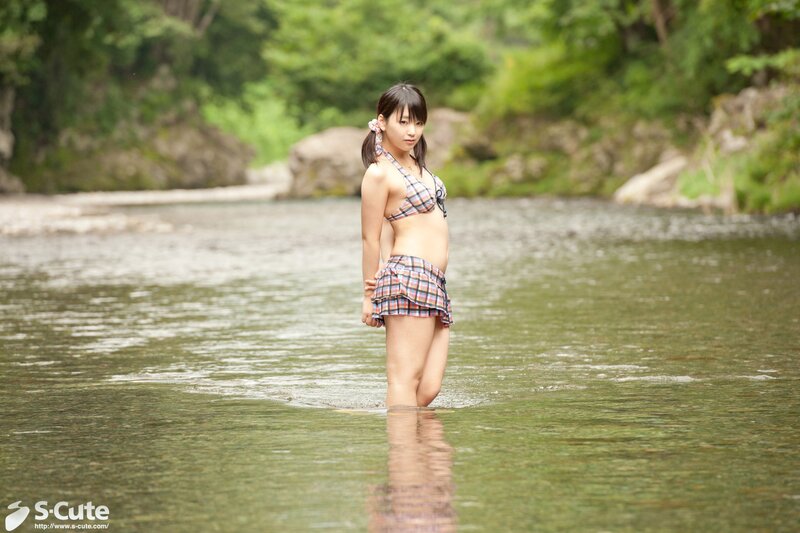 Girl in plaid swimsuit at river
