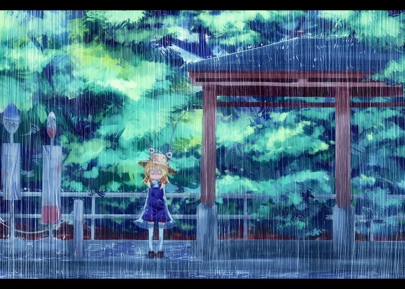 Girl in rain under a gazebo