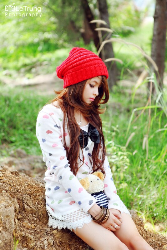Girl in red hat with teddy bear
