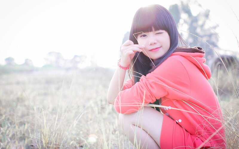 girl in red hoodie winking