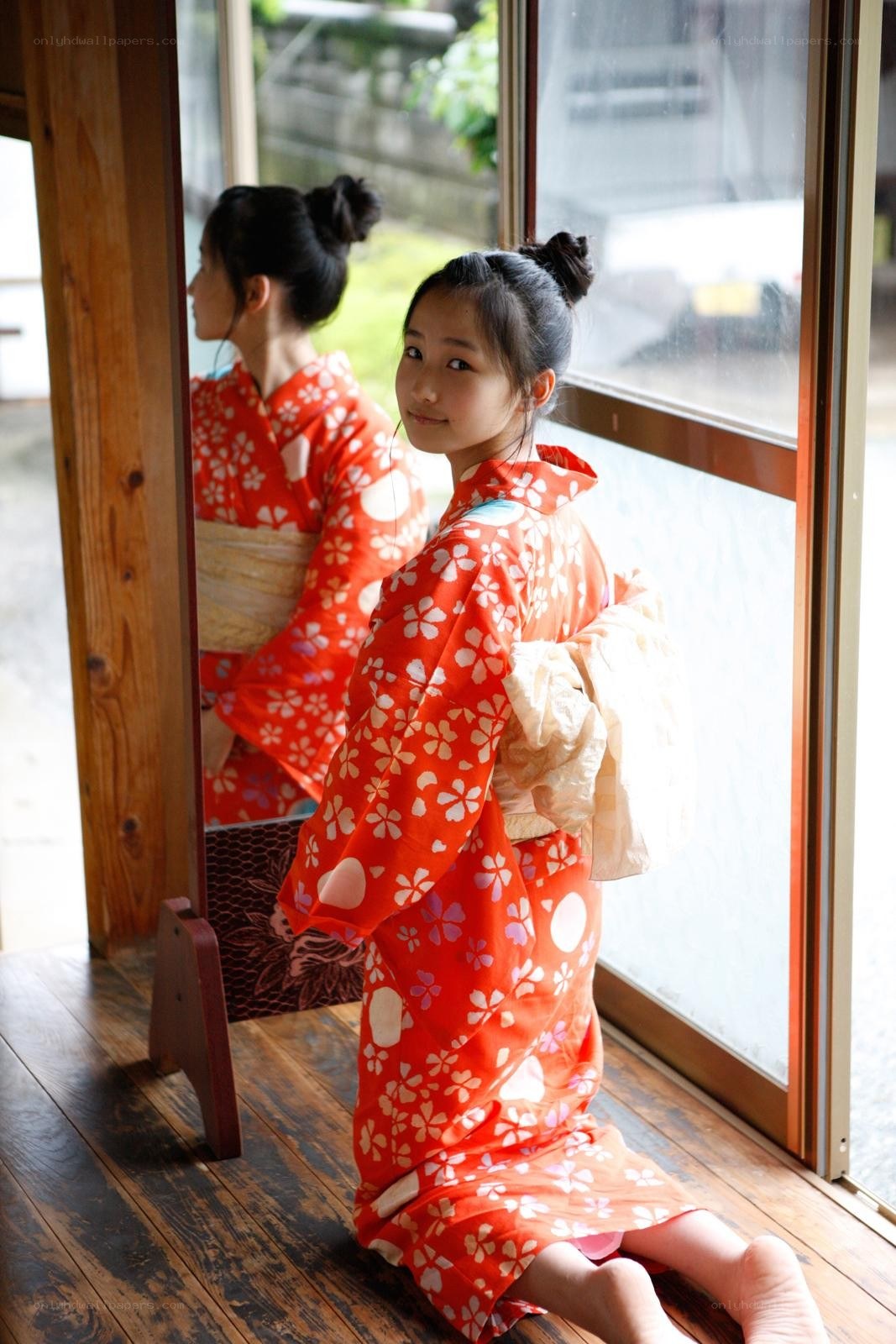 Girl in red kimono by window