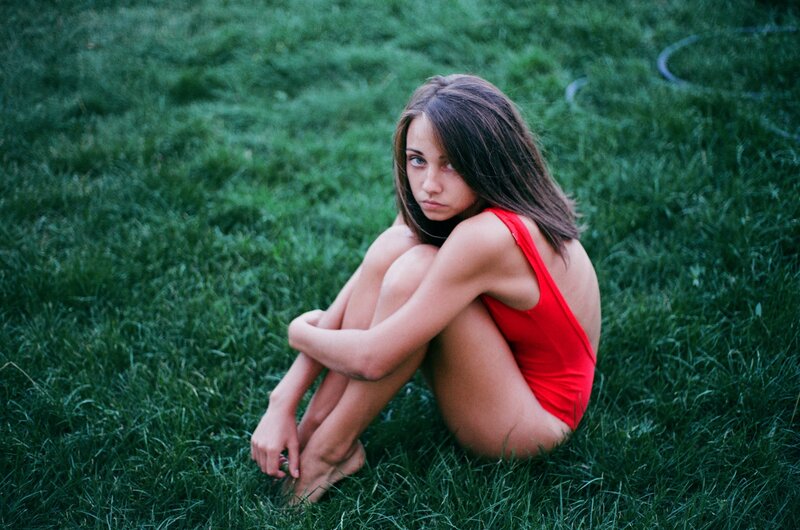 Girl in red swimsuit on grass