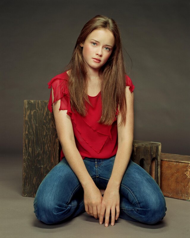 girl in red top sitting on floor