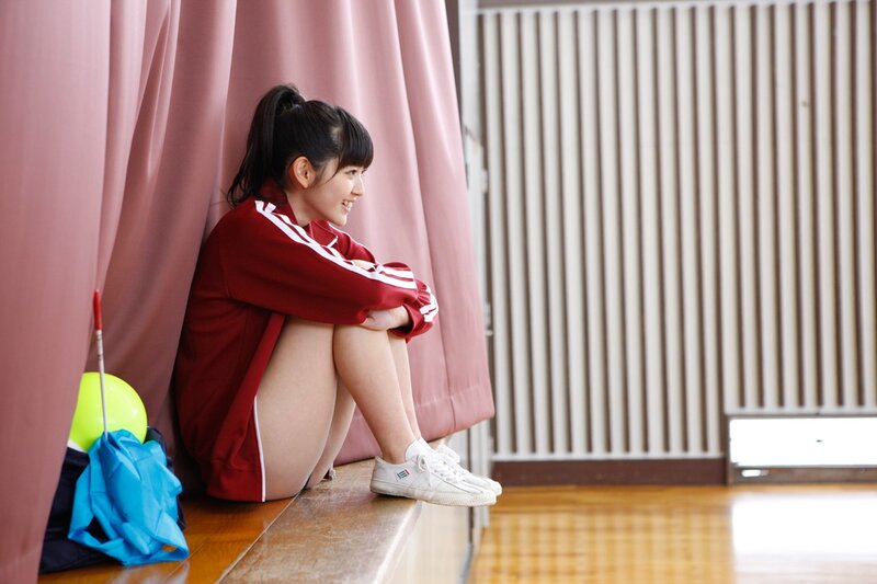 Girl in red tracksuit sitting