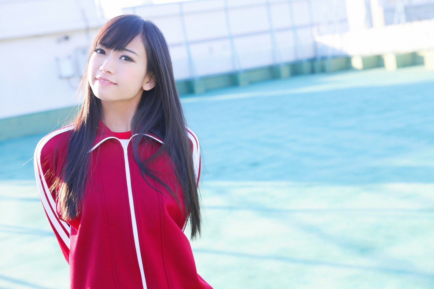 girl in red tracksuit smiling