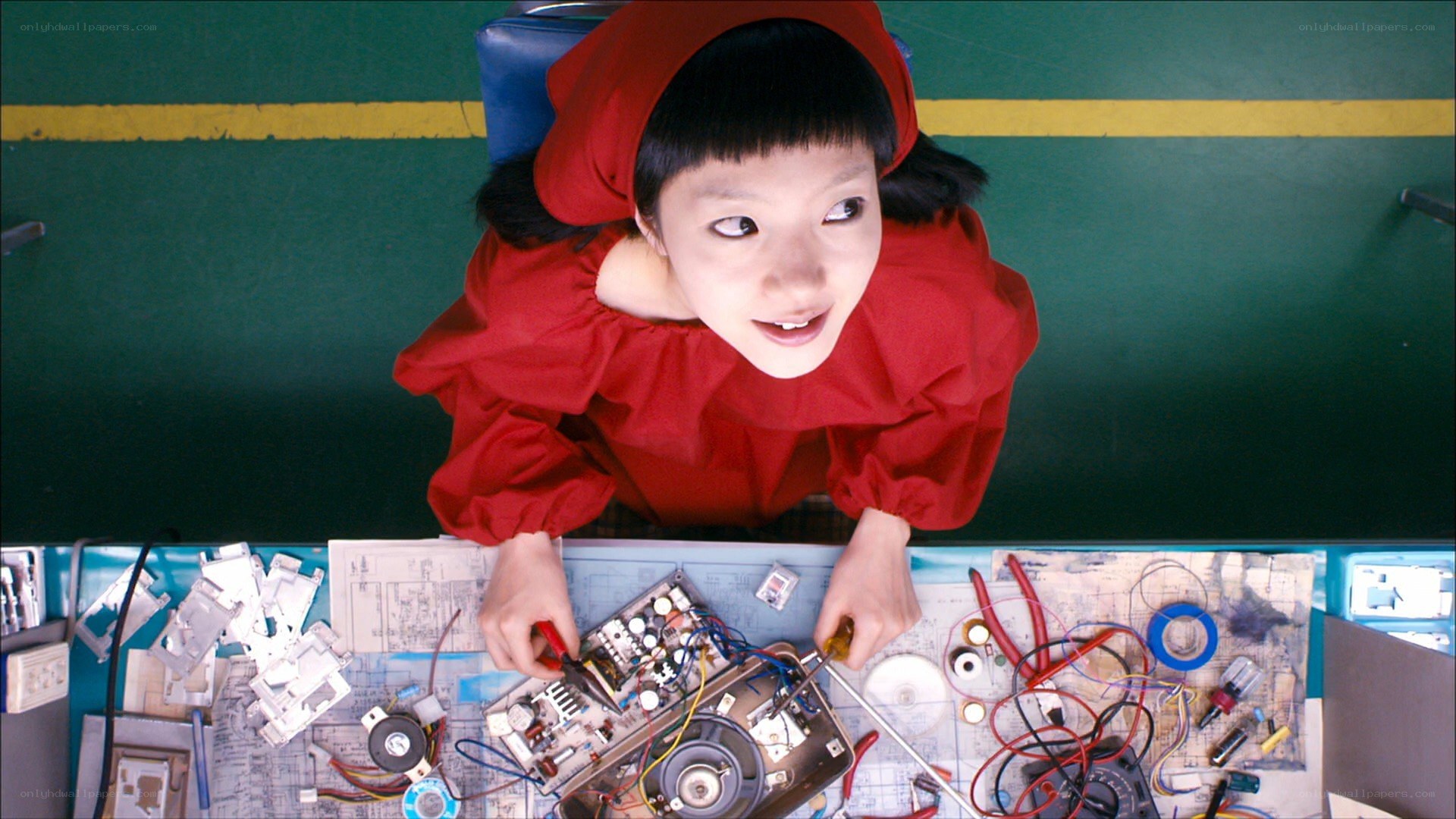 girl in red working on electronics