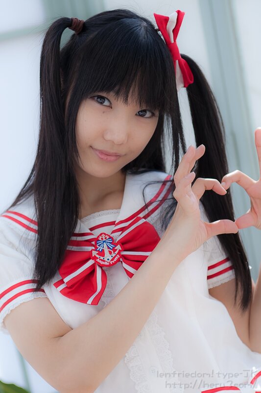 girl in sailor outfit making heart