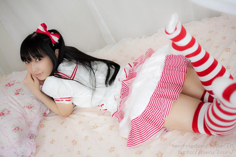 girl in sailor outfit on bed