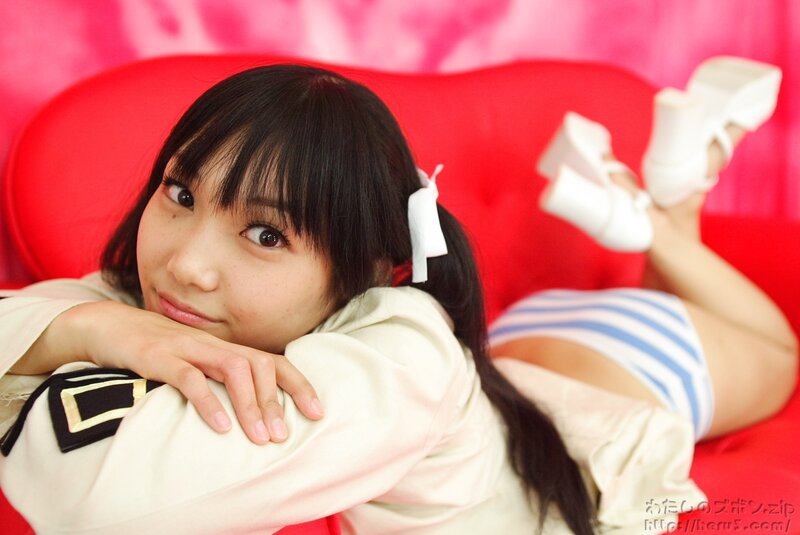 girl in sailor outfit on red couch