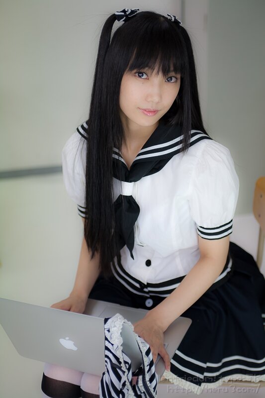 girl in sailor uniform with laptop