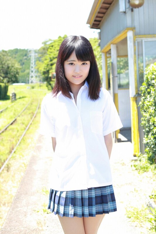 girl in school uniform at train station