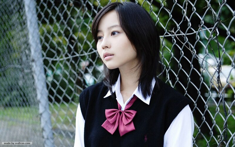 girl in school uniform by fence