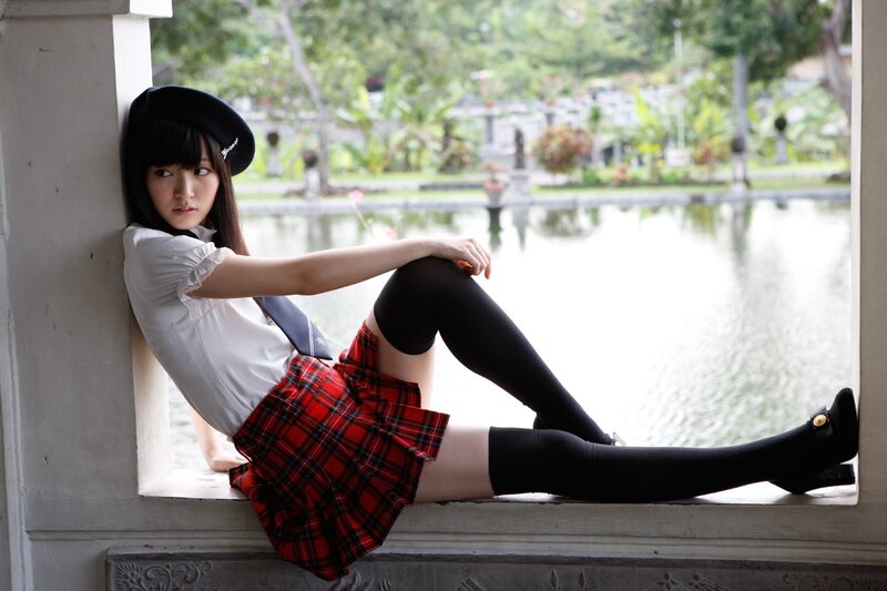 girl in school uniform by pond