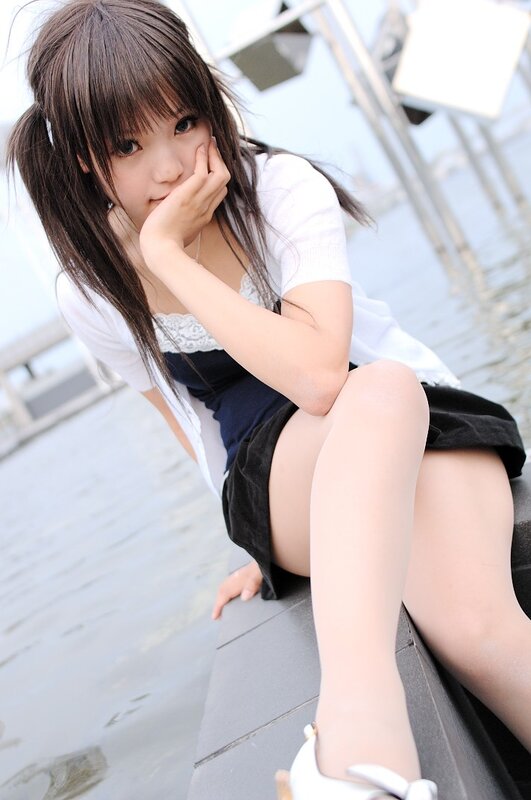 girl in school uniform by water