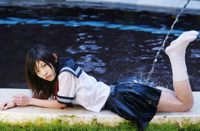 girl in school uniform by water