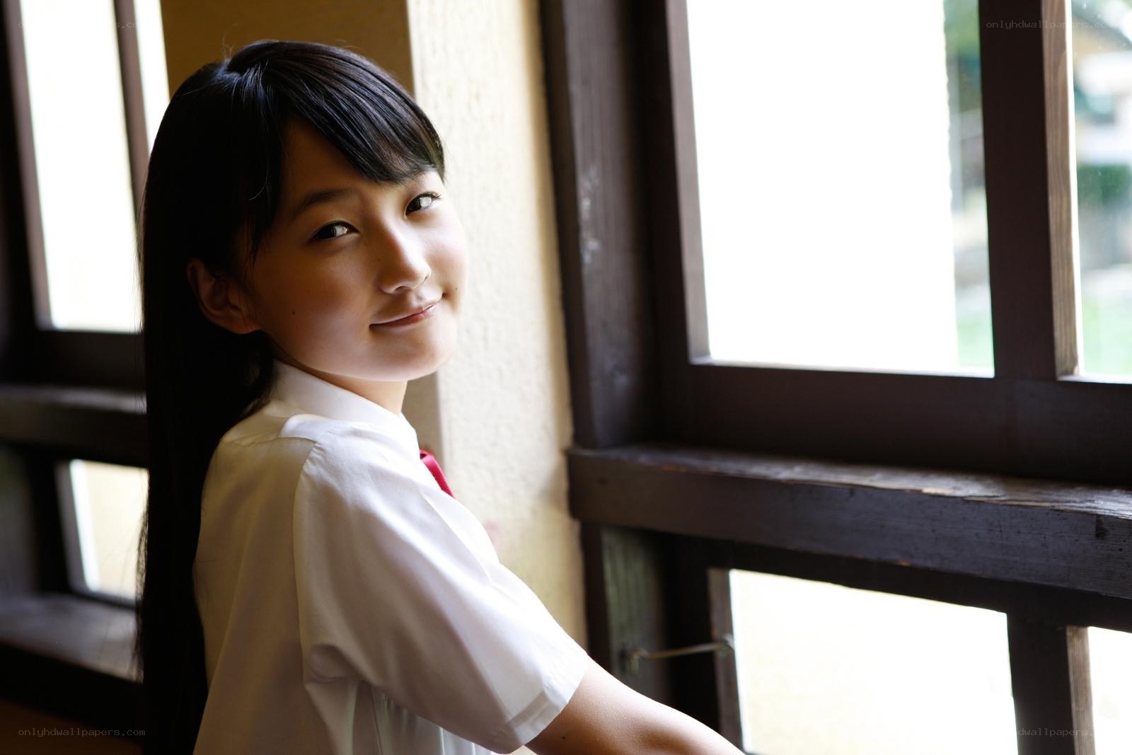girl in school uniform by window