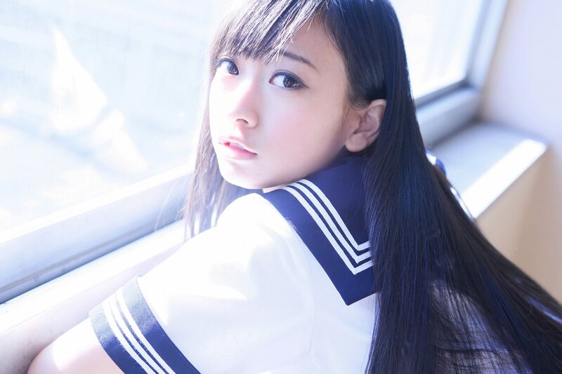 girl in school uniform by window
