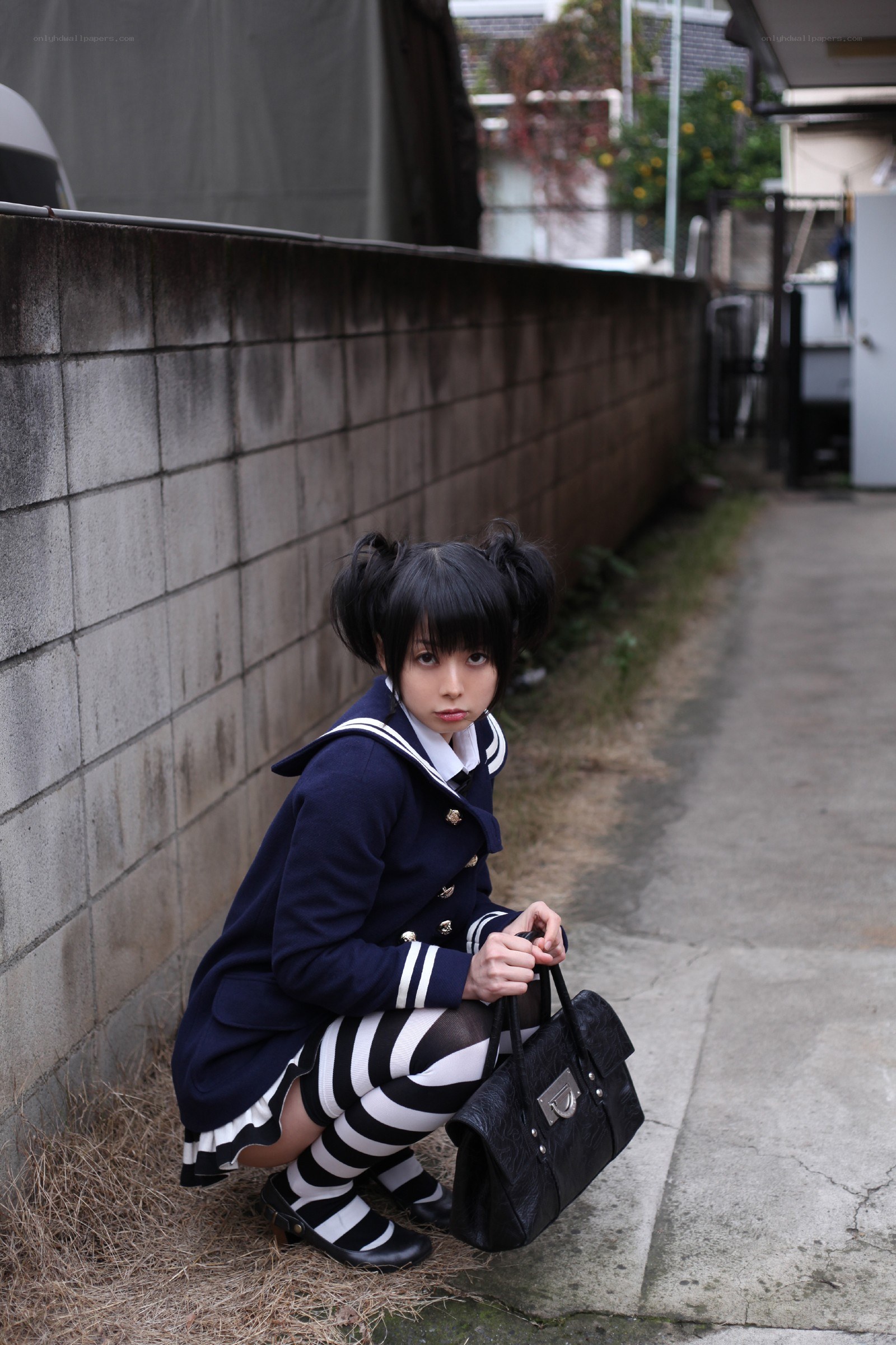 girl in school uniform crouching