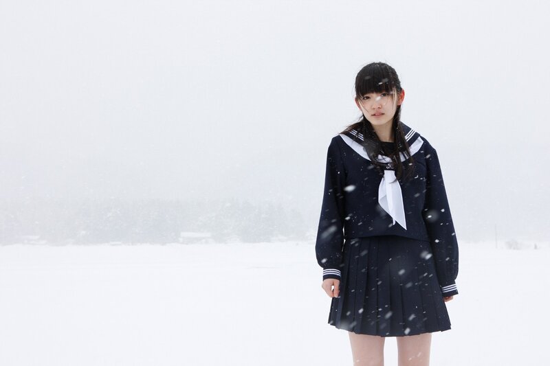 Girl in school uniform in snow