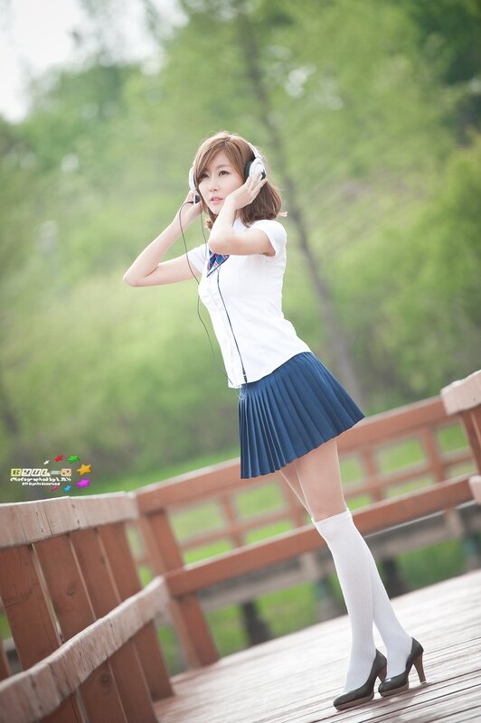 girl in school uniform listening to music