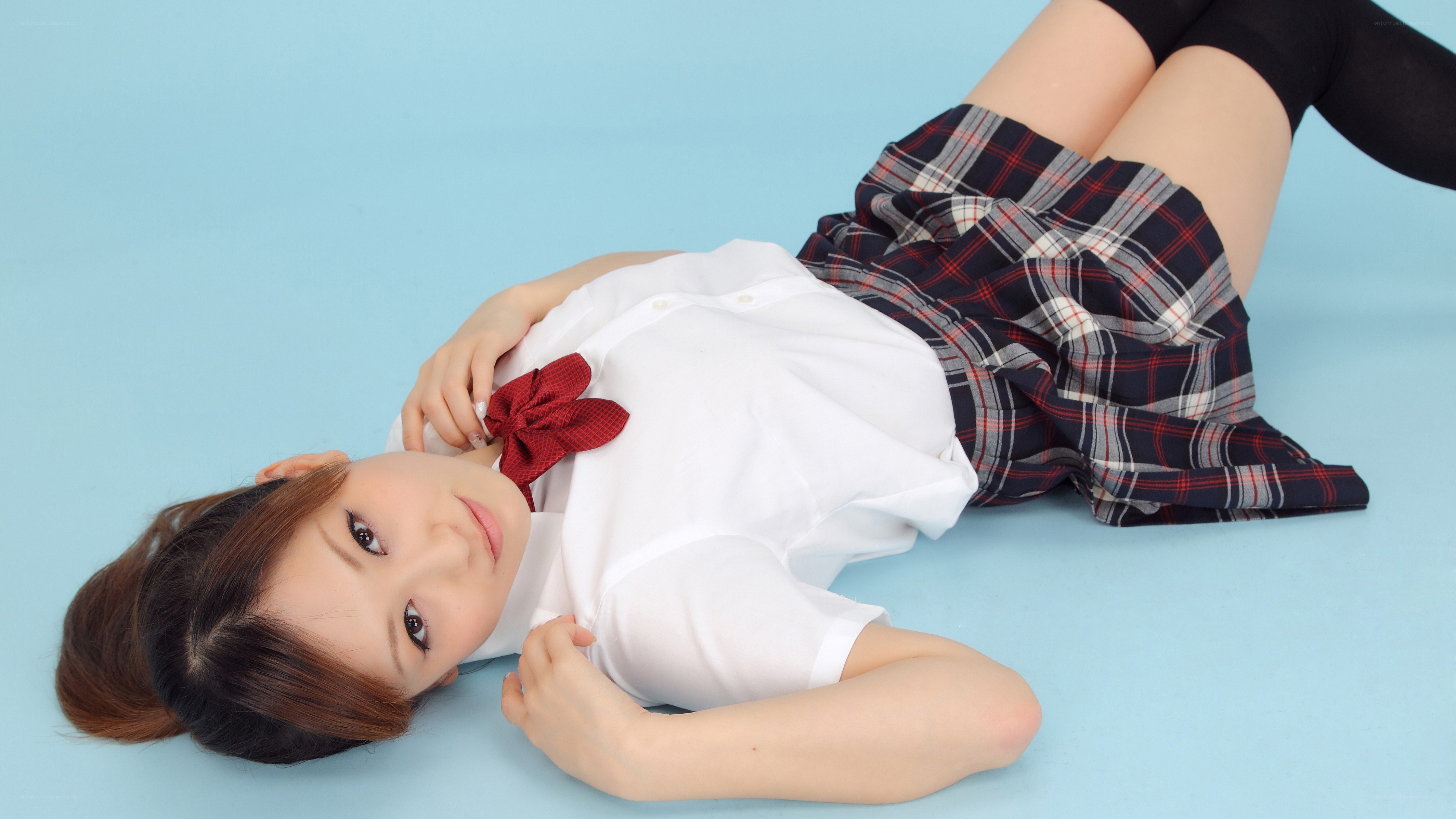 girl in school uniform lying down