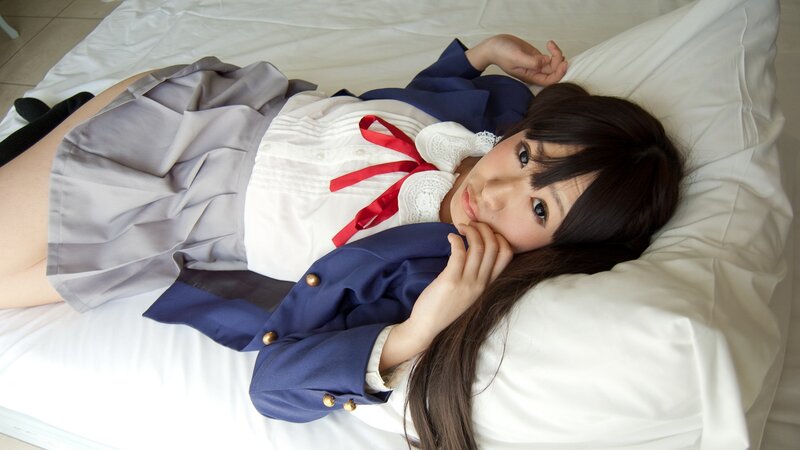 girl in school uniform lying on bed