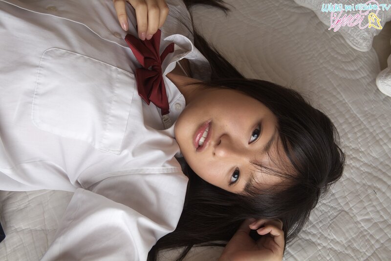 girl in school uniform lying on bed