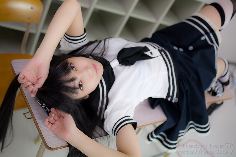 girl in school uniform lying on desk