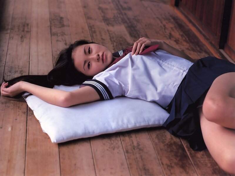 Girl in school uniform lying on floor