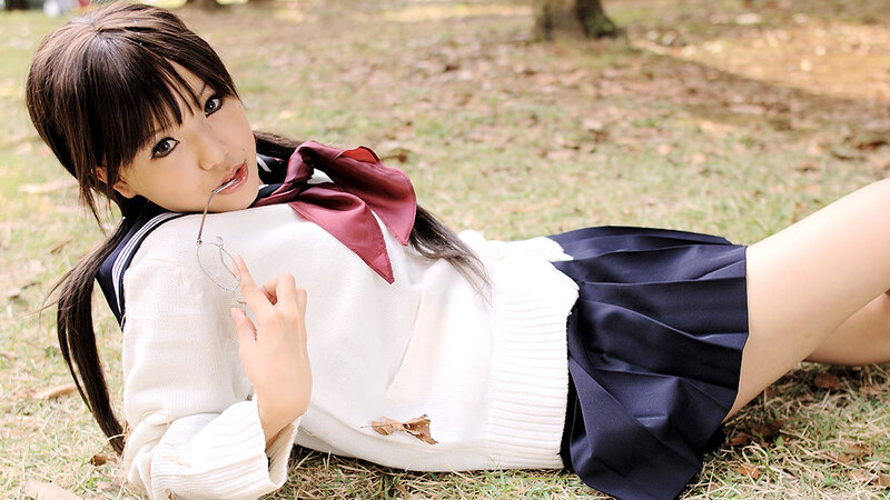 girl in school uniform lying on grass